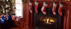 Christmas stockings hung from the mantlepiece above a wood burner stove